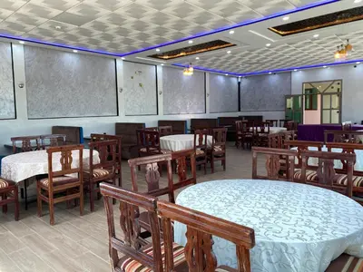 a dining room with tables and chairs and a room with tables and chairsktop at IGHIZ INN resort in Er Rachidia
