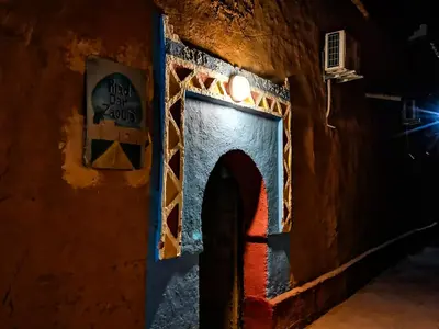 an entrance to a building at night at Riad Dar Zaouia in Zagora
