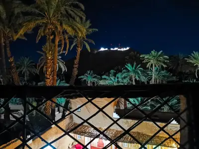 a view of the resort from the balcony at night at Riad Dar Zaouia in Zagora
