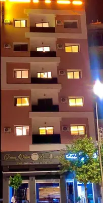 a tall building with many windows on the side of it at HOTEL CAFE PALAIS SALAM , Beni Mellal in Beni Mellal