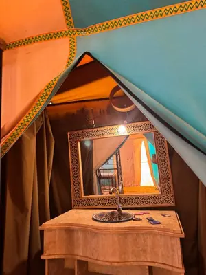 a mirror on top of a table in a tent at Hotel ksar merzouga in Merzouga