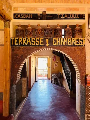 an archway in a building with a sign that reads terraceasy chchanges at Kasbah Tialouite in Kalaat MGouna