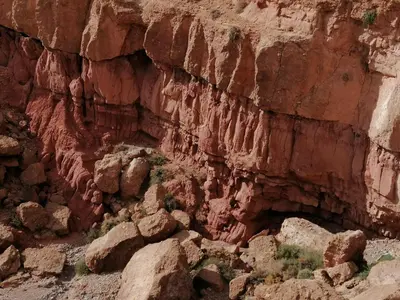 a canyon with some rocks and plants in it at Kasbah Tialouite in Kalaat MGouna