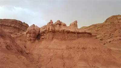 a desert hillside with some rocks on it at Kasbah Tialouite in Kalaat MGouna