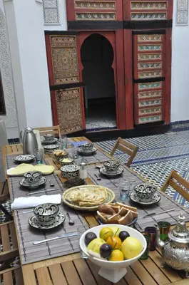 a table with plates of food on top of it at Dar 7 Louyat in Fès