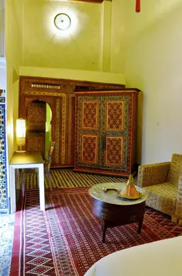 a living room with a couch and a table at Dar 7 Louyat in Fès
