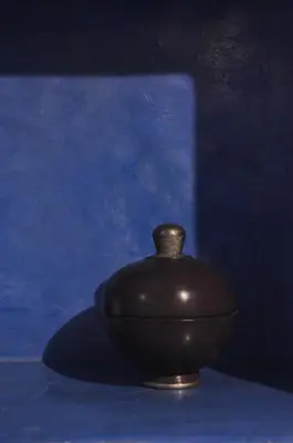 a brown vase sitting on a blue table at Dar 7 Louyat in Fès