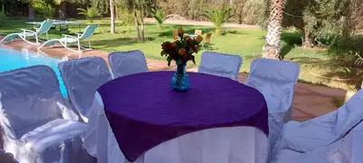 a table with a vase of flowers on it at villa Marrakech raja in Marrakech