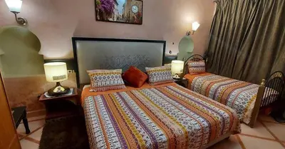 a hotel room with two beds and two lamps at villa Marrakech raja in Marrakech