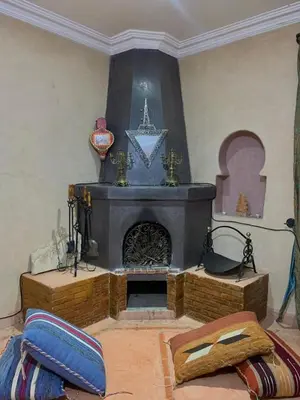 a living room with a fireplace in a room at villa Marrakech raja in Marrakech