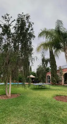 a park with two trees and a picnic table at villa Marrakech raja in Marrakech