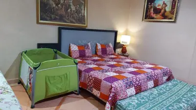 a bedroom with a bed and a chair in it at villa Marrakech raja in Marrakech