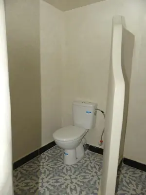 a bathroom with a toilet in a room at Dar Diafa Chez Anaam in Er Rachidia