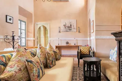 a living room with a couch and a table at Villa Pauline with private pool & jacuzzi, hotel service and no insight in Marrakech