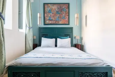 a bed with a green headboard in a bedroom at Villa Pauline with private pool & jacuzzi, hotel service and no insight in Marrakech