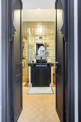 an open door to a bathroom with a tv at Villa Pauline with private pool & jacuzzi, hotel service and no insight in Marrakech