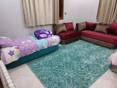 a living room with a bed and a couch at The good stay 3 in Midelt