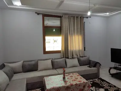 a living room with a couch and a table at The good stay 3 in Midelt