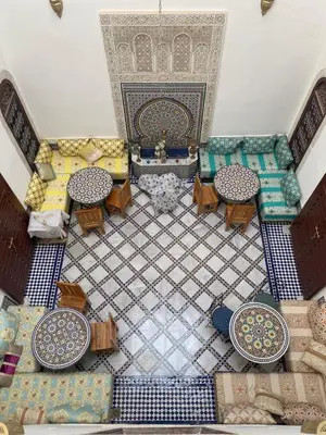 an overhead view of a living room with tables and chairs at Riad Fes Colors & SPA - Family Lodging in Fès