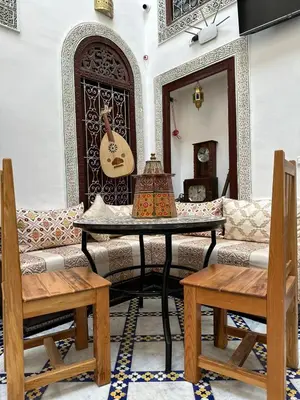 a living room with a couch and a table at Riad Fes Colors & SPA - Family Lodging in Fès