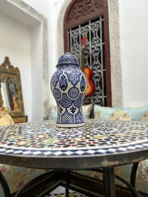 a blue and white vase sitting on a table at Riad Fes Colors & SPA - Family Lodging in Fès