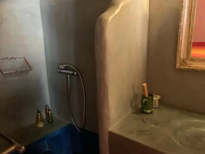 a bathroom with a shower and a sink at RIAD CHANT D'ETOILES tadighoust in El Hara