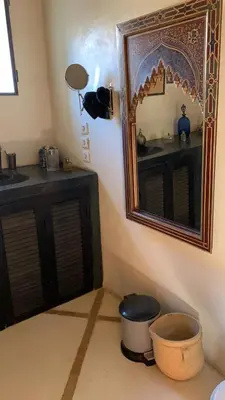 a bathroom with a sink and a mirror and a bowl at RIAD CHANT D'ETOILES tadighoust in El Hara