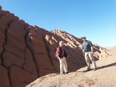 two people standing on a rock in the desert at Auberge IMIN TAGHYA in Akhendachou nʼAït Ouffi