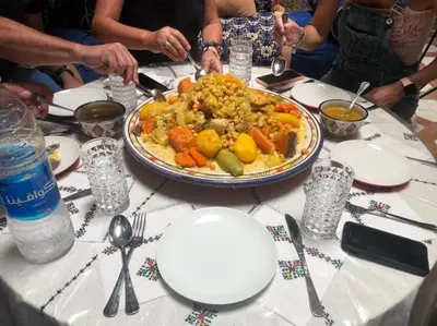 a table with a plate of food on top of it at Riad Abqari Youssefi in Fès