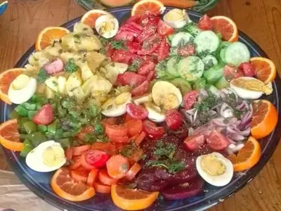 a plate of fruit and vegetables on a table at AUBERGE KACHTi in Mhamid