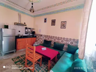 a living room with a couch and a table at Chalets ITO Atlas Timnay in Midelt