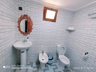 a bathroom with a sink and a toilet and a mirror at Chalets ITO Atlas Timnay in Midelt