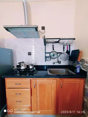 a kitchen counter with a sink and a stove at Chalets ITO Atlas Timnay in Midelt
