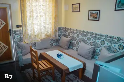 a living room with a couch and a table at Chalets ITO Atlas Timnay in Midelt