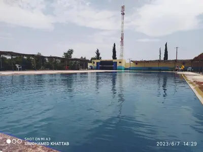 a large pool of water in front of a building at Chalets ITO Atlas Timnay in Midelt