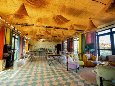 a large room with tables and chairs and a large ceiling at Maison Daouia in Marrakech