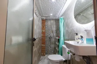 a bathroom with a shower and a toilet and a sink at FIFI maison in Ouarzazate