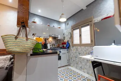 a kitchen with white cabinets and a basket on the counter at FIFI maison in Ouarzazate