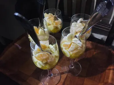 four wine glasses filled with fruit on a wooden table at Riad ait Ben Haddou in Aït Ben Haddou