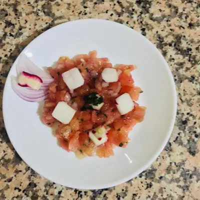 a white plate with a dish of food on a table at Riad ait Ben Haddou in Aït Ben Haddou