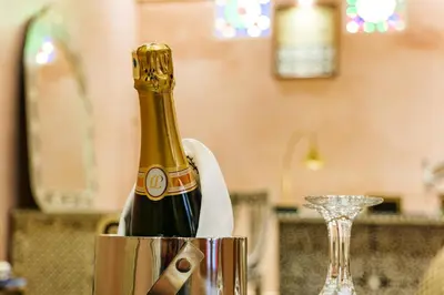 a bottle of champagne in a can on a table at Riad Rcif Alif Suite & SPA in Fès