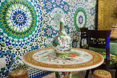 a vase sitting on a table in a room with tiles at Riad Rcif Alif Suite & SPA in Fès