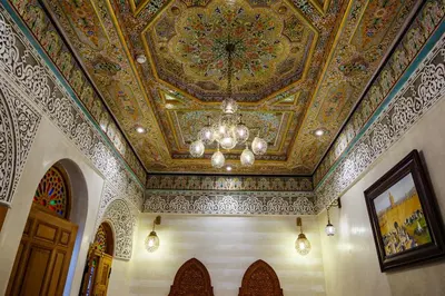 a room with a ceiling with a chandelier at Riad Rcif Alif Suite & SPA in Fès