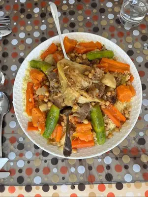 a bowl of food with meat and vegetables on a table at Relais Des Nomades in Tinerhir