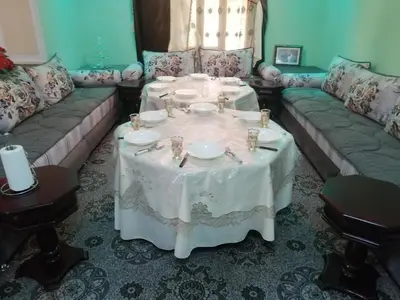 a living room with a table and a couch at Assounfou in Ouarzazate