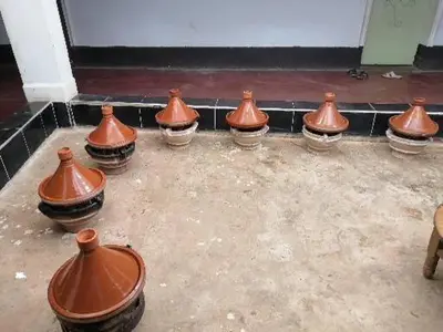 a group of orange vases sitting on the ground at Assounfou in Ouarzazate