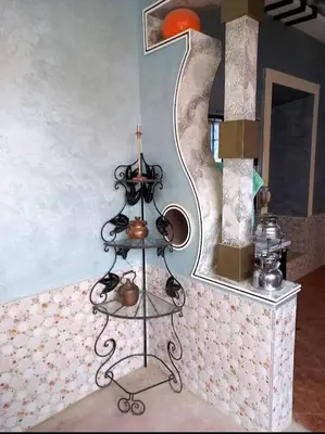 a room with a shelf with tea pots and a mirror at Assounfou in Ouarzazate
