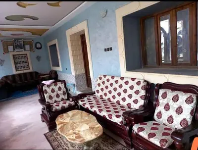 a living room with a couch and two chairs at Assounfou in Ouarzazate