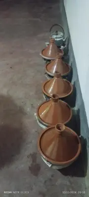 a row of copper bowls lined up in a row at Assounfou in Ouarzazate