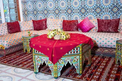 a living room with a couch and a red table at Dar Lmrama Fes - Entire Guest House in Fès